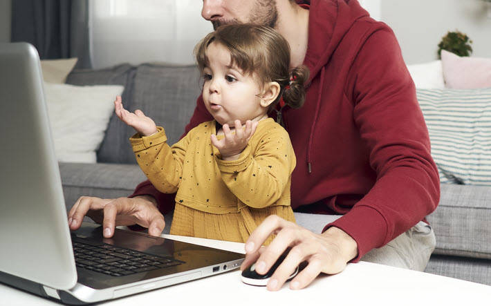 Little girl confused in front of lap top computer