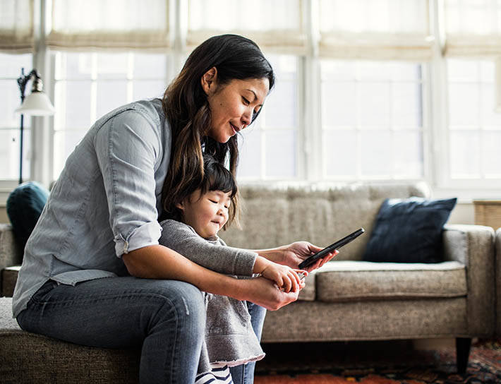 mother with toddler looking at mobile phone
